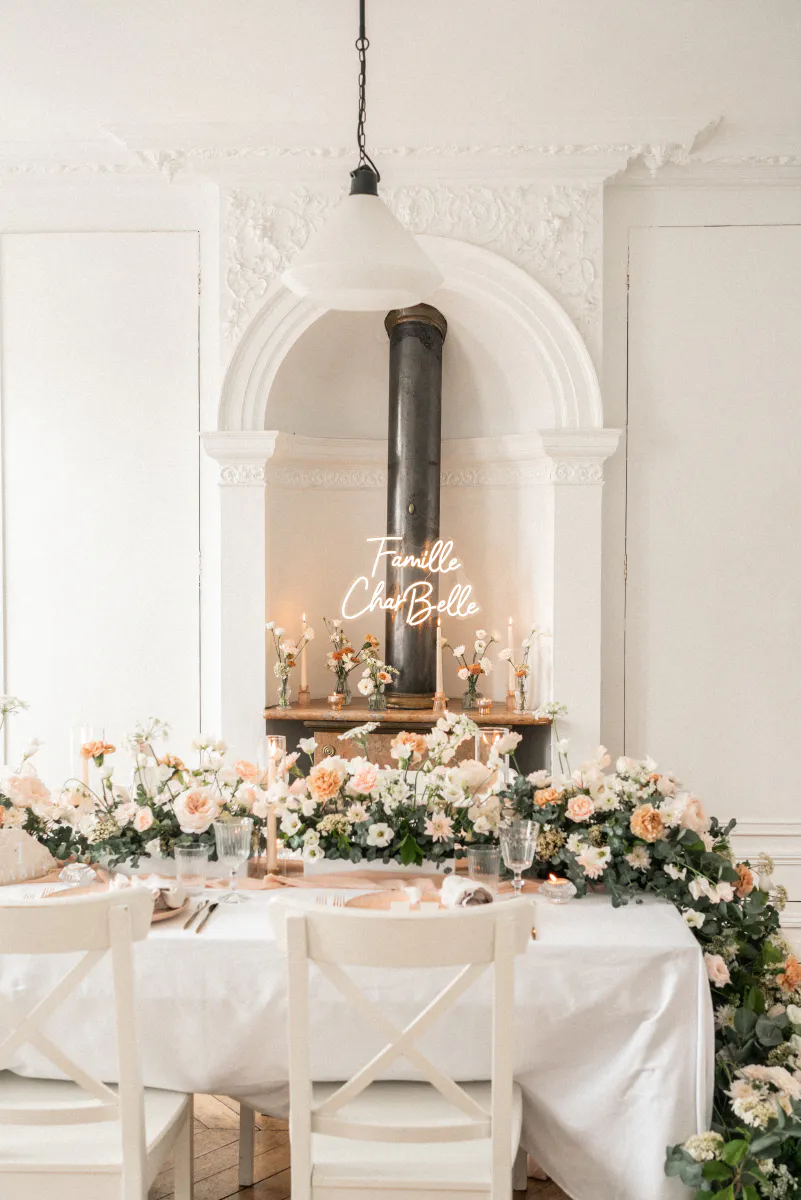 Table d'honneur fleurie dans un salon blanc
